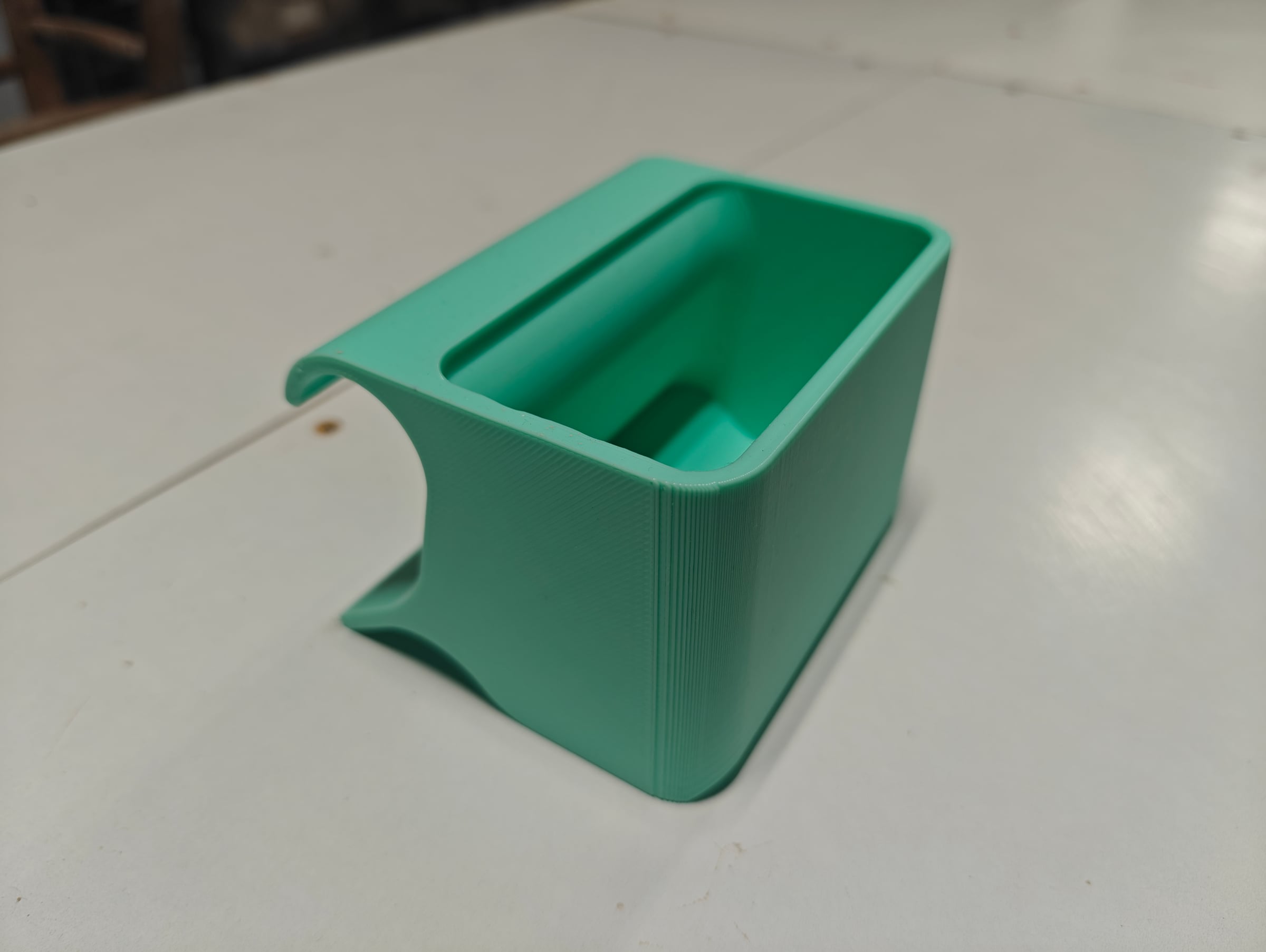 Mint 3D-printed pottery tool caddy on a studio table