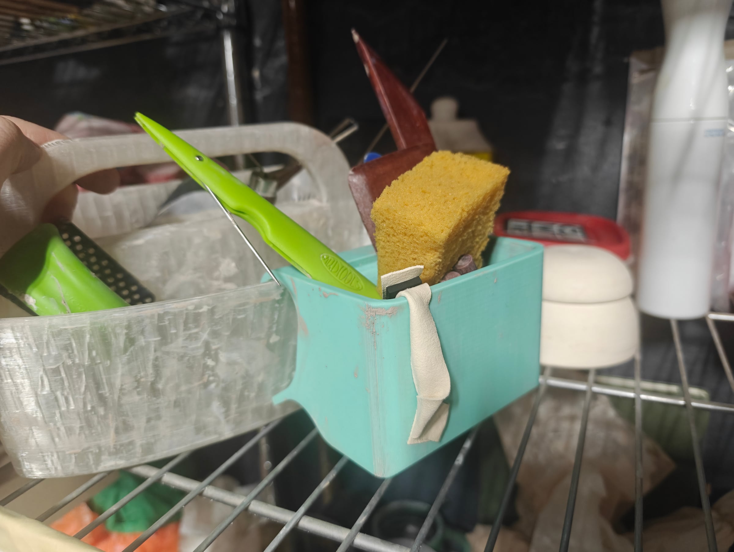 Tool caddy clipped to a wire studio shelf