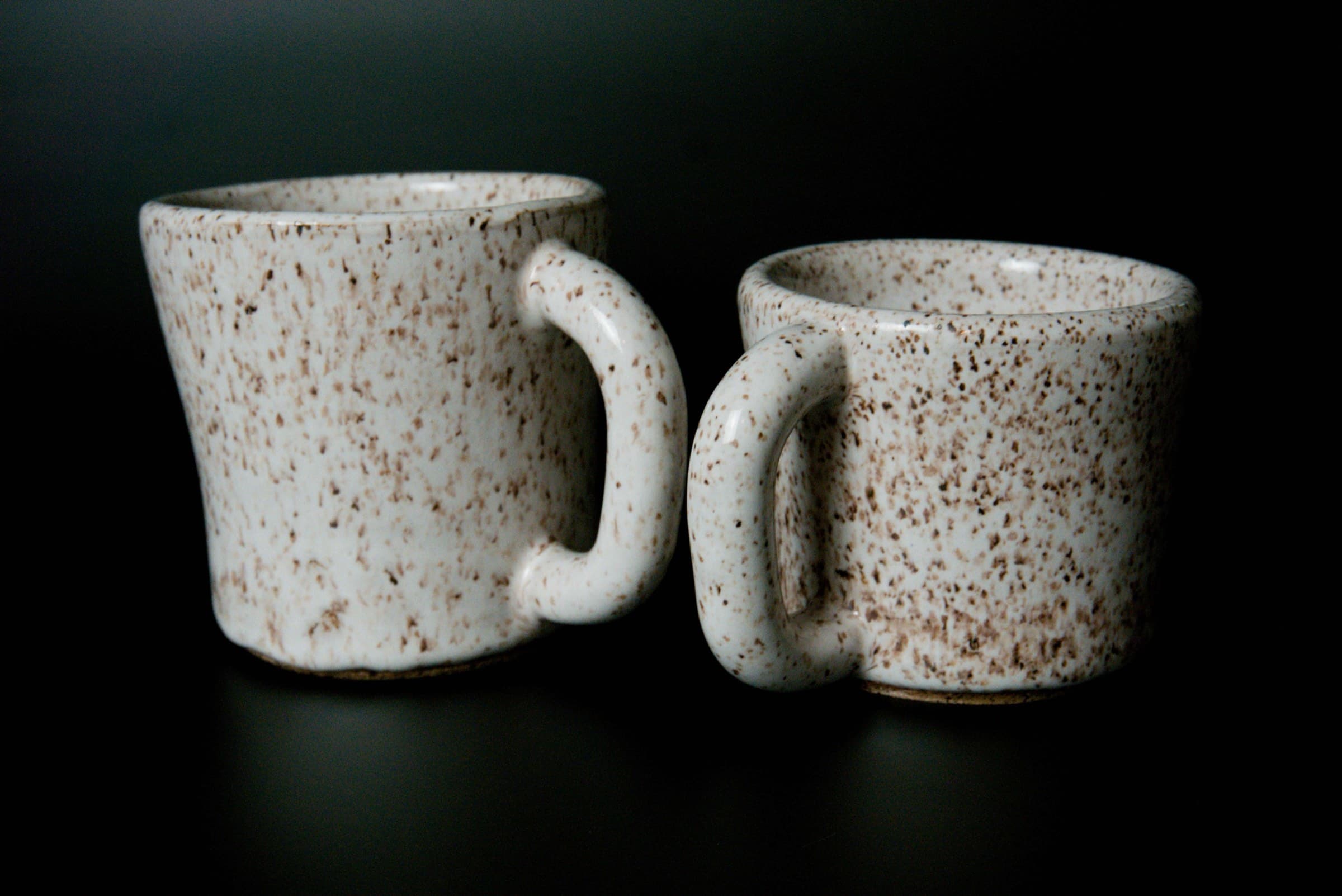 A pair of handmade speckled mugs from mudstone studio
